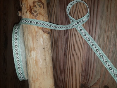Dekoratīva kokvilnas apdares lenta ar 'akas' rakstu